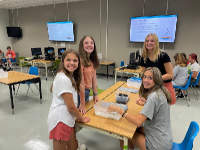 Junior High students smile for the camera as they engage in fun activites in the STEAM Lab